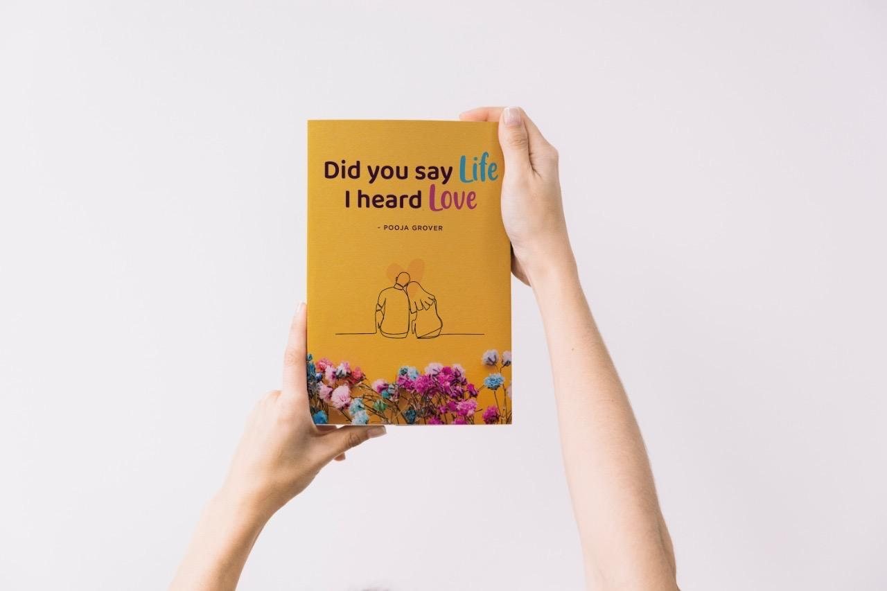 Did You Say Life, I Heard Love — a book by Pooja Grover, held up in two hands